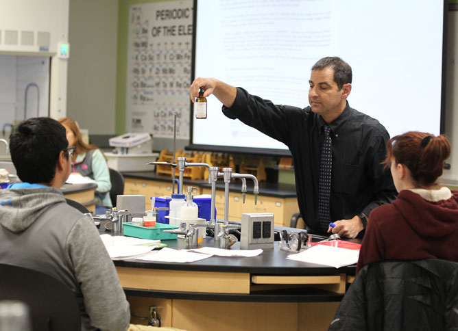 An Oakton College professor teaches in front of students.