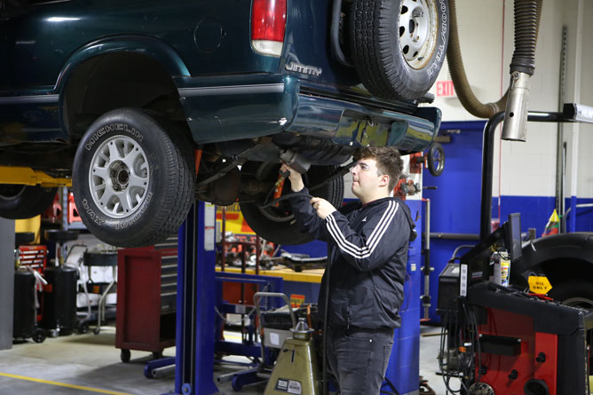 Oakton students work on a car.